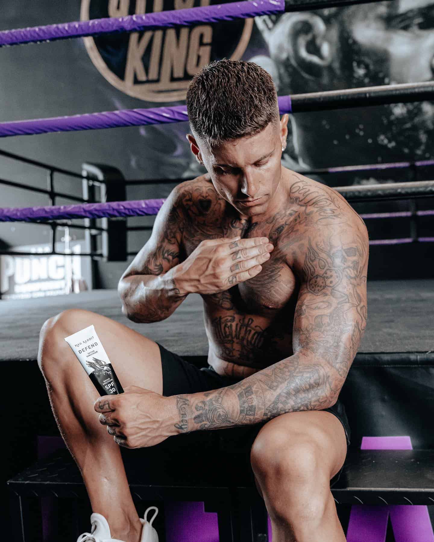 an athlete applying an aftercare tattoo cream