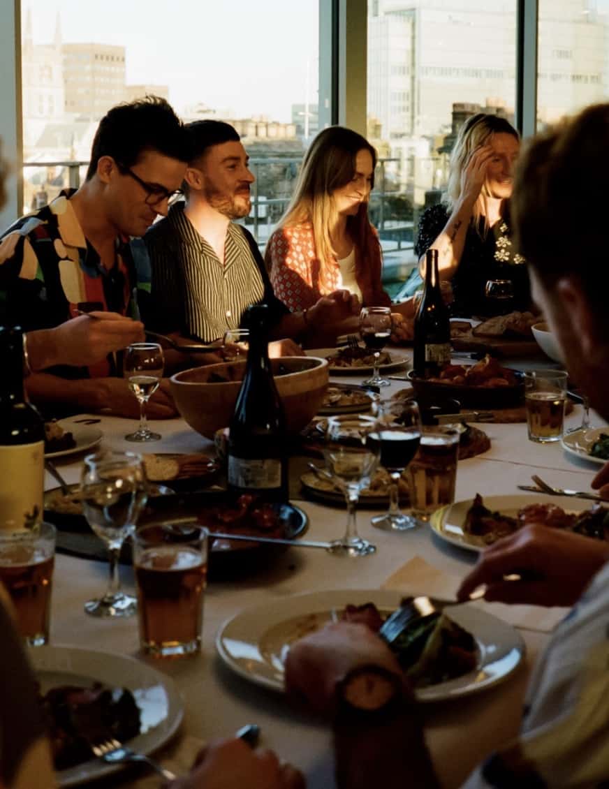 People sitting at a table eating a meal