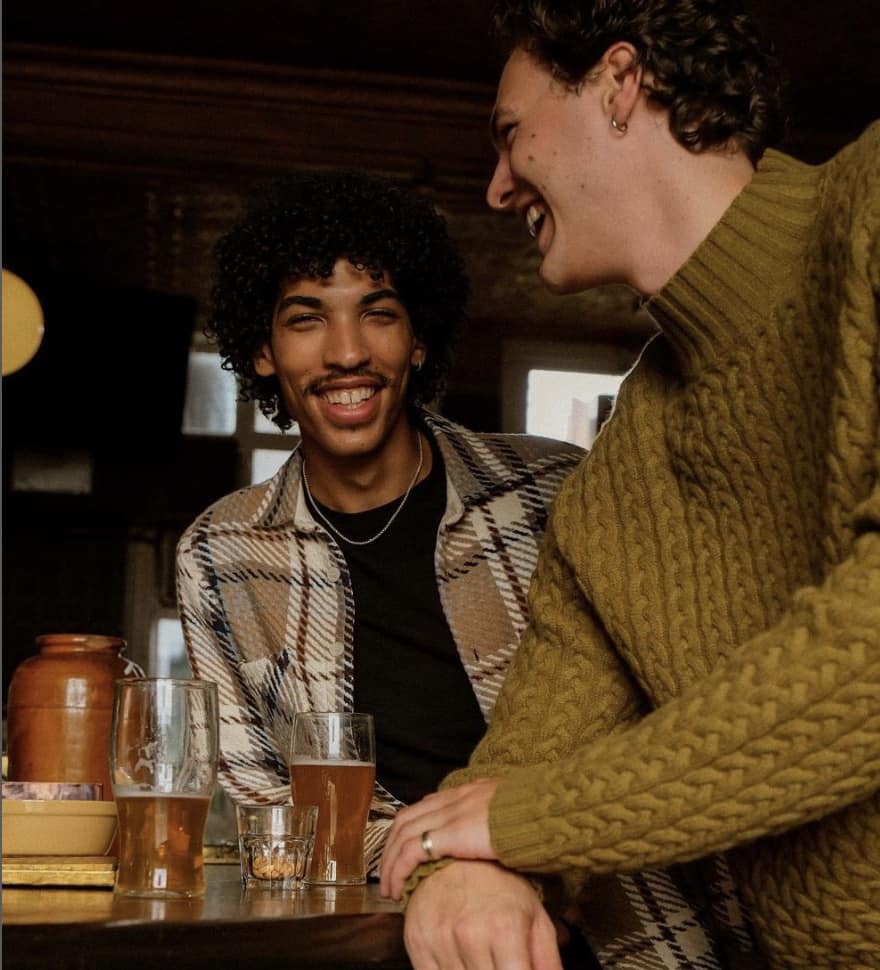 men having a drink at a bar